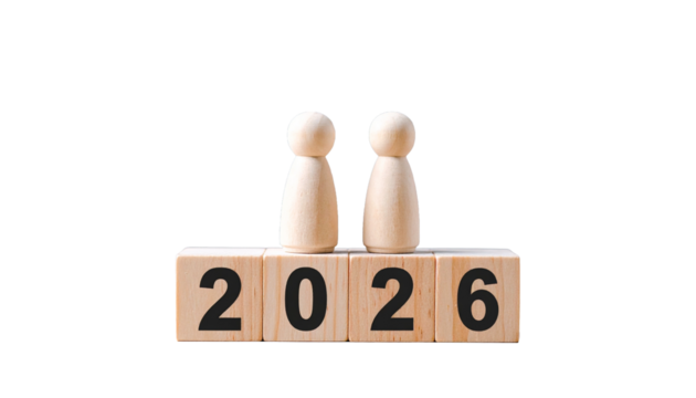 a visual representation of the year 2026 with wooden figures. The wooden figures stand atop blocks that spell out the year 2026, set against an unobtrusive backdrop.