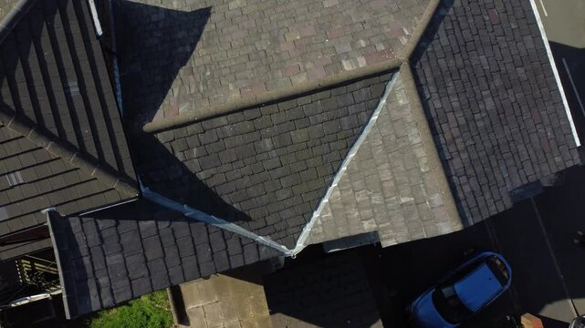 Rooftop inspection aerial view inspecting damage and repair of property real estate for homeowner