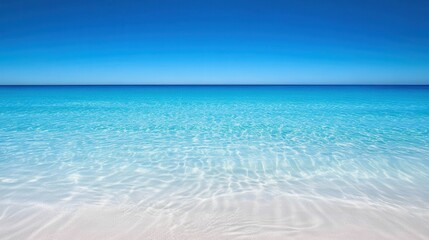 Obraz premium Clear turquoise water over white sand beach.
