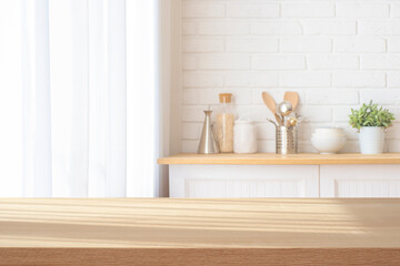 Table top with sunlight shadows for product display on blurred kitchen counter interior background