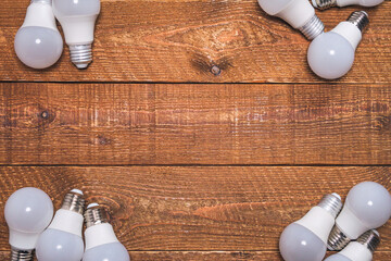 LED bulbs are lying on the table in different corners of the frame
