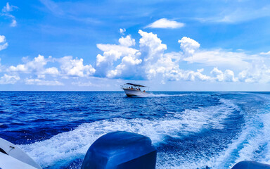 Boat trip Cancun Mexico to Island with deep blue seascape.