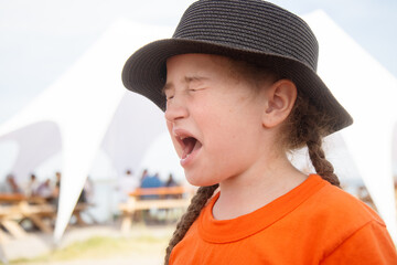 girl grimacing after tasting something sour