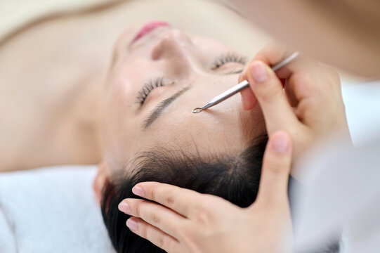 Female Facial Extraction Treatment by Professional Esthetician at Spa