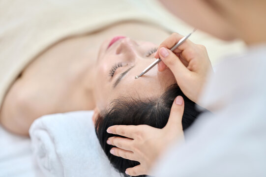 Female Facial Extraction Treatment by Professional Esthetician at Spa