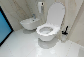 A modern toilet with neat paper protection in a clean white bathroom
