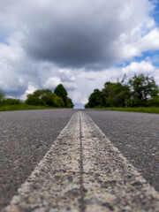 A long empty road with a white line on the side of it