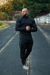 Muscular man in sportswear outdoor. Athletic male outside
