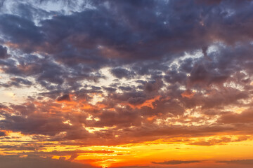 A vibrant sunset sky with orange and red colors as a background or texture