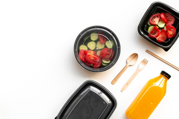 Tomatoes salad in plastic delivery tray, top view. Catering concept