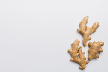 Finely dry Ginger powder in bowl with green leaves isolated on colored background. top view flat lay