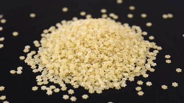Dry star shaped stelline pasta close-up. World Paste Day concept.