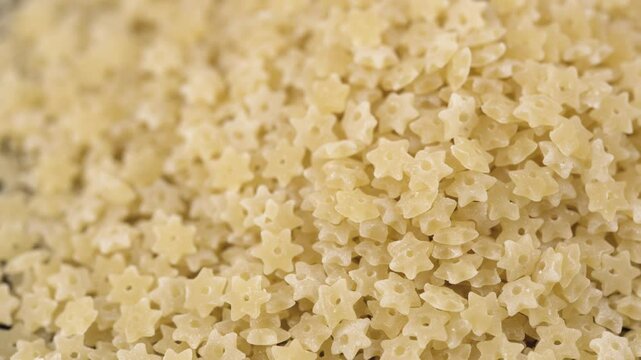 Dry star shaped stelline pasta close-up. World Paste Day concept.