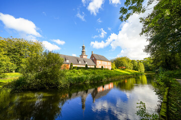 Obraz premium View of the castle near Husum, near the town of Husum in the North Frisia district. Husum Castle with the surrounding landscape. 
