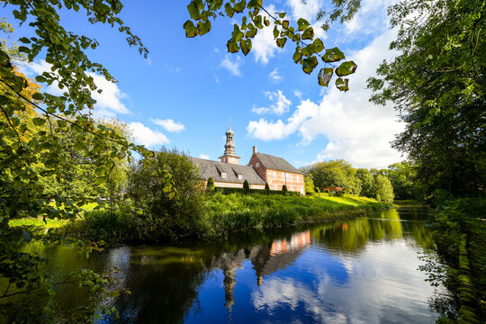 View of the castle near Husum, near the town of Husum in the North Frisia district. Husum Castle with the surrounding landscape.
