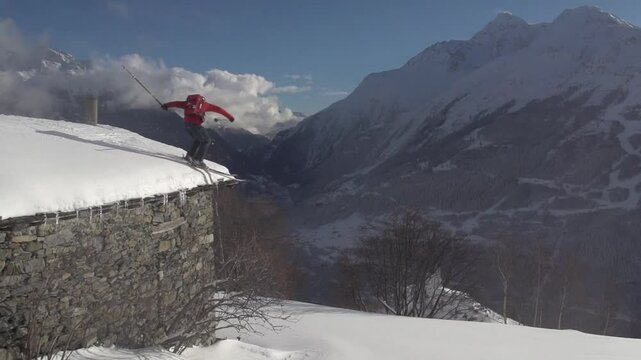 Saut d'un muret en pierre en ski