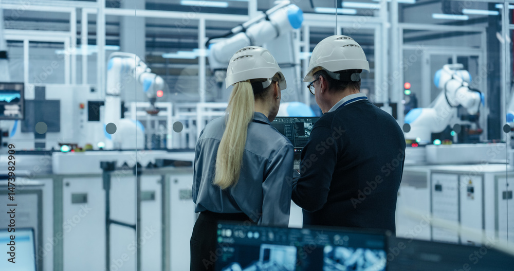 Poster Female and Male Industrial Engineers Monitoring and Analyzing Conditions at a Modern Tech Electronics Factory with Automated Robot Arms Working with the Help of Artificial Intelligence Software