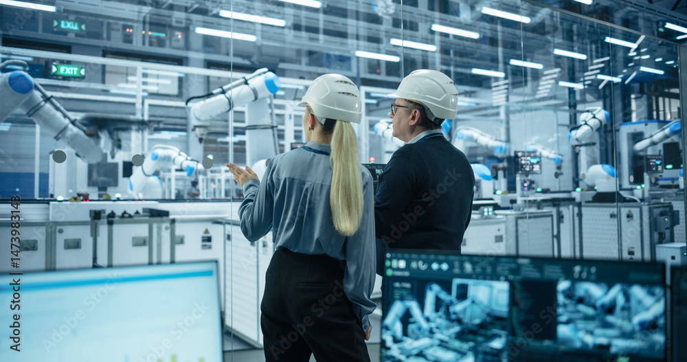 Poster Female and Male Industrial Engineers Monitoring and Analyzing Conditions at a Modern Tech Electronics Factory with Automated Robot Arms Working with the Help of Artificial Intelligence Software