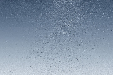 Metallic background with light blue gradient and rough texture creating an abstract pattern