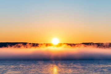 Fototapeta premium Sunrise over misty water with vibrant colors in the sky. Healthy air atmosphere concept.