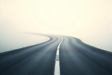 Serene winding asphalt road with gentle curves disappearing into a soft, ethereal mist, creating a sense of mystery and endless possibilities for journey