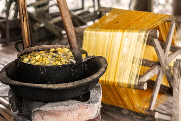 Fototapeta na wymiar boiling silkworm cocoons traditional silk production method in cambodia
