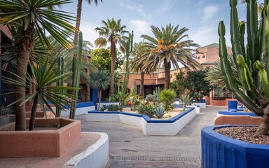 Fototapeta premium Summer Santorini, Greece, Moroccan garden courtyard with palms and cacti