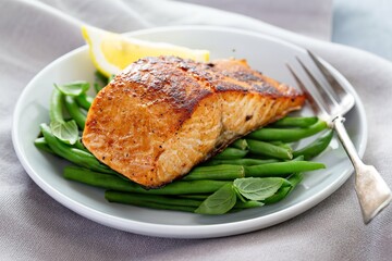Grilled blackened salmon served with green beans and lemon