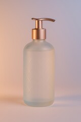 Frosted glass pump bottle with a rose gold dispenser, featuring subtle geometric patterns, set against a soft gradient background