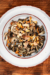 assortment of aromatic dried forest mushrooms on a plate.