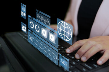 A person types on a keyboard while digital icons for online ads, emails, files, media, and web browsing float above the screen, symbolizing digital marketing and online advertising activities.