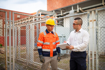 Electrical engineers are checking the performance of electrical transformers in an industrial...
