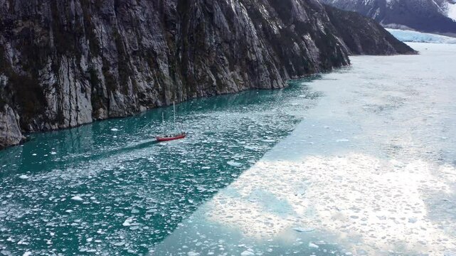 Fisherman Boat Isolated On Frozen Waterways Across Cape Horn In Beagle Channel Of Argentina. Aerial Drone Shot