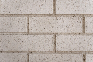 Close-up of textured white brick wall, ideal for use as background or modern architectural detail.