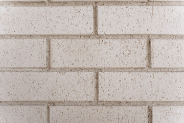 Close-up of textured white brick wall, ideal for use as background or modern architectural detail.