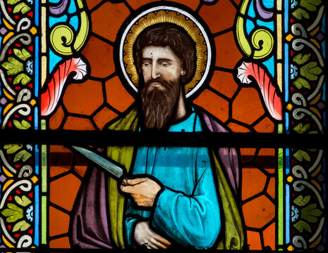 Stained glass (19th century) of St. Bartholomew the Apostle depicted with a knife. Catholic saint.