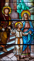 Obraz premium Stained glass (19th century) of Holy family: Jesus infant, Virgin Mary and St Joseph the carpenter.