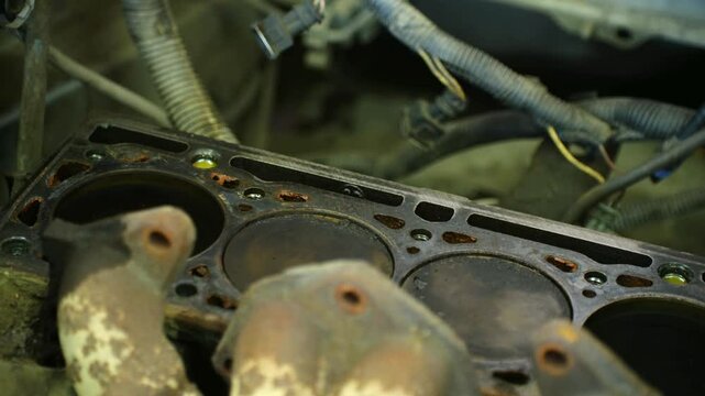 Worn cylinder head gasket revealing advanced deterioration, signaling critical engine component damage needing professional mechanical assessment and potential replacement