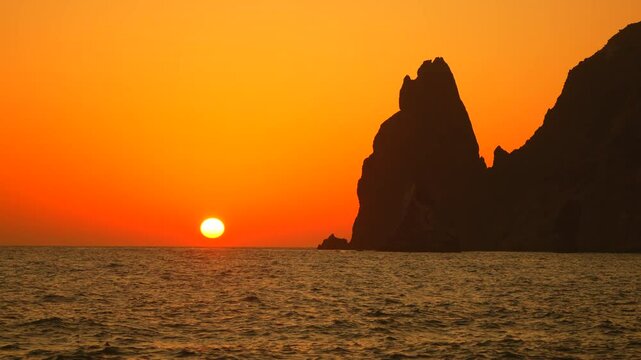 Sunset Rocks Cabo San Lucas Baja California Mexico: Dramatic ocean cliff silhouette during vibrant sunset.