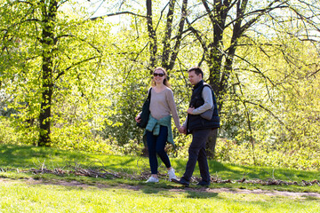 Fototapeta premium A Joyful Stroll Through Nature A Couple Enjoying the Fresh Air on a Sunny Day