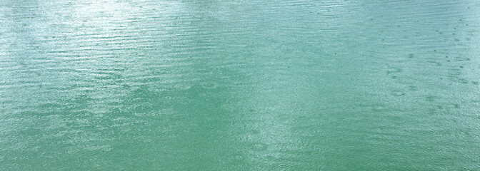 River in the rain. Water surface during a downpour, rainy season,