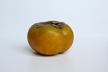 A persimmon fruit, isolated on white background