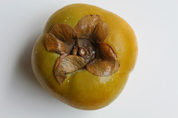 A persimmon fruit, isolated on white background, flat lay or top view
