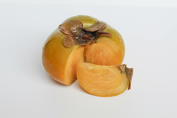 Cut flesh persimmon fruit, isolated on white background