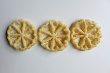 Kembang goyang cake, traditional snack from Indonesia. Fried dough in wheel or flower shaped. Isolated on white backgroun