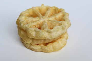 Kembang goyang cake, traditional snack from Indonesia. Fried dough in wheel or flower shaped. Isolated on white backgroun