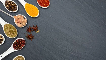 Cooking spices arrangement kitchen counter food photography dark slate background top-down view culinary inspiration © MODERNARTWatChaRaWit