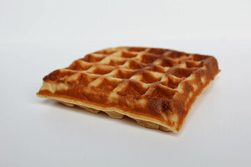One plain square waffle cake, burnt side, isolated on white background