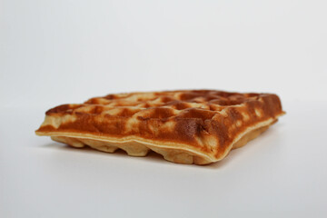 One plain square waffle cake, burnt side, isolated on white background