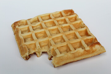 One bitten waffle cake, isolated on white background